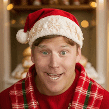 a man wearing a santa hat and a red sweater smiles