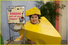 a woman dressed in a cheese costume with a sign saying cheese out of my league