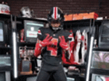 a football player wearing a helmet and gloves is standing in front of a locker room .