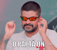 a man wearing sunglasses says o pai ta on in a foreign language