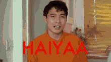 a man in an orange shirt says haiyaa