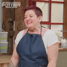 a woman wearing an apron is smiling in front of a sign that says " the great canadian pottery throw down "