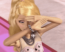 a barbie doll wearing a necklace and bracelet covering her face