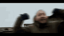 a blurry picture of a man with his arms up