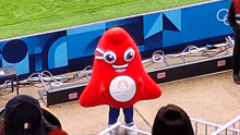 a mascot for the harry potter olympics is standing in front of a crowd