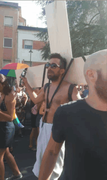 a shirtless man is holding a sign that says ' i love you ' on it