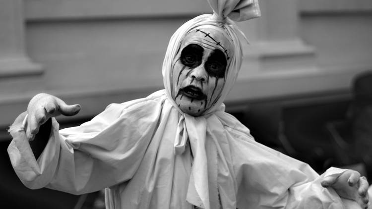 A person dressed as a pocong ghost in Bandung, Indonesia