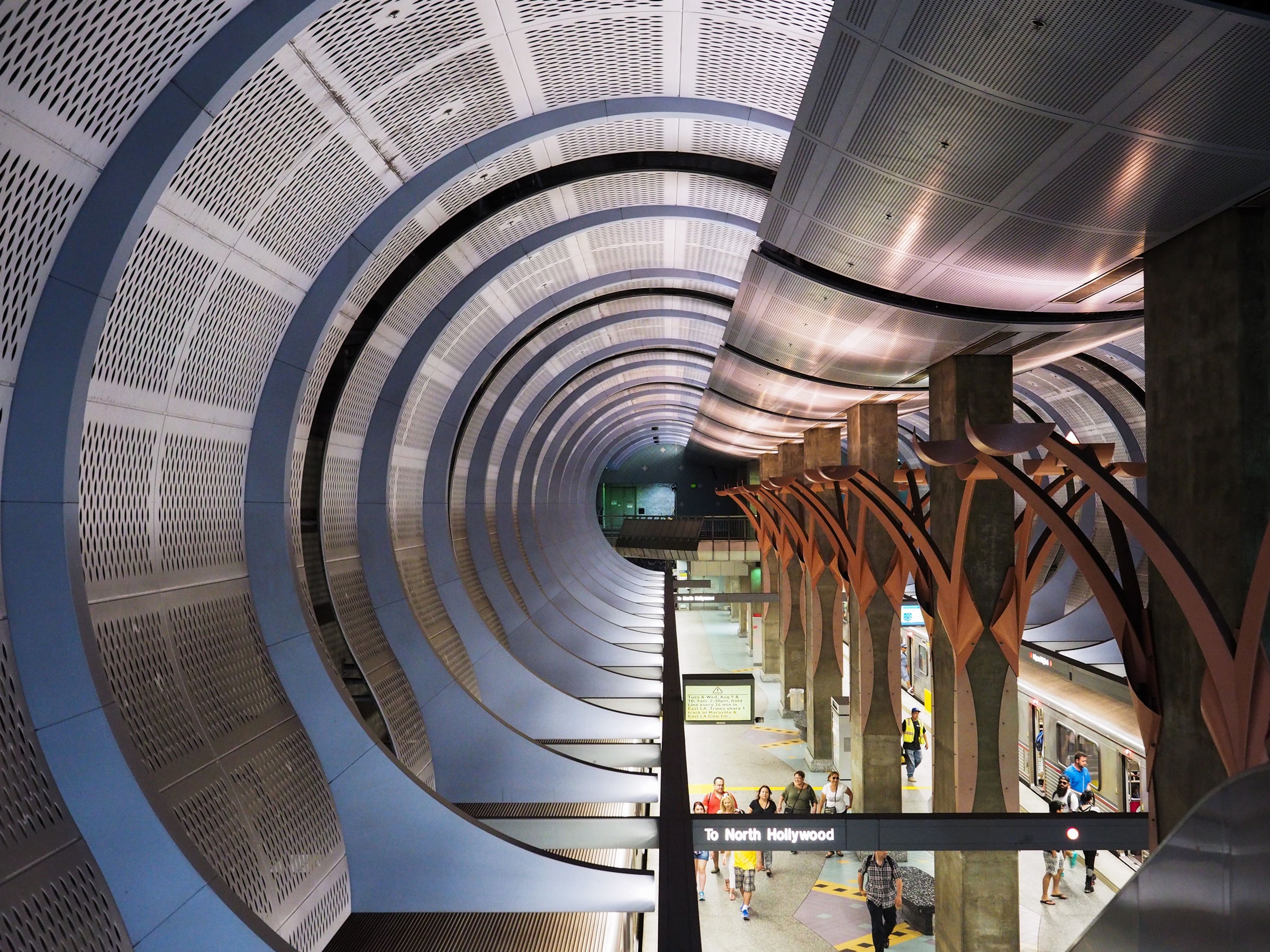 high up view of the red line metro station in Los Angeles with trains and passengers below