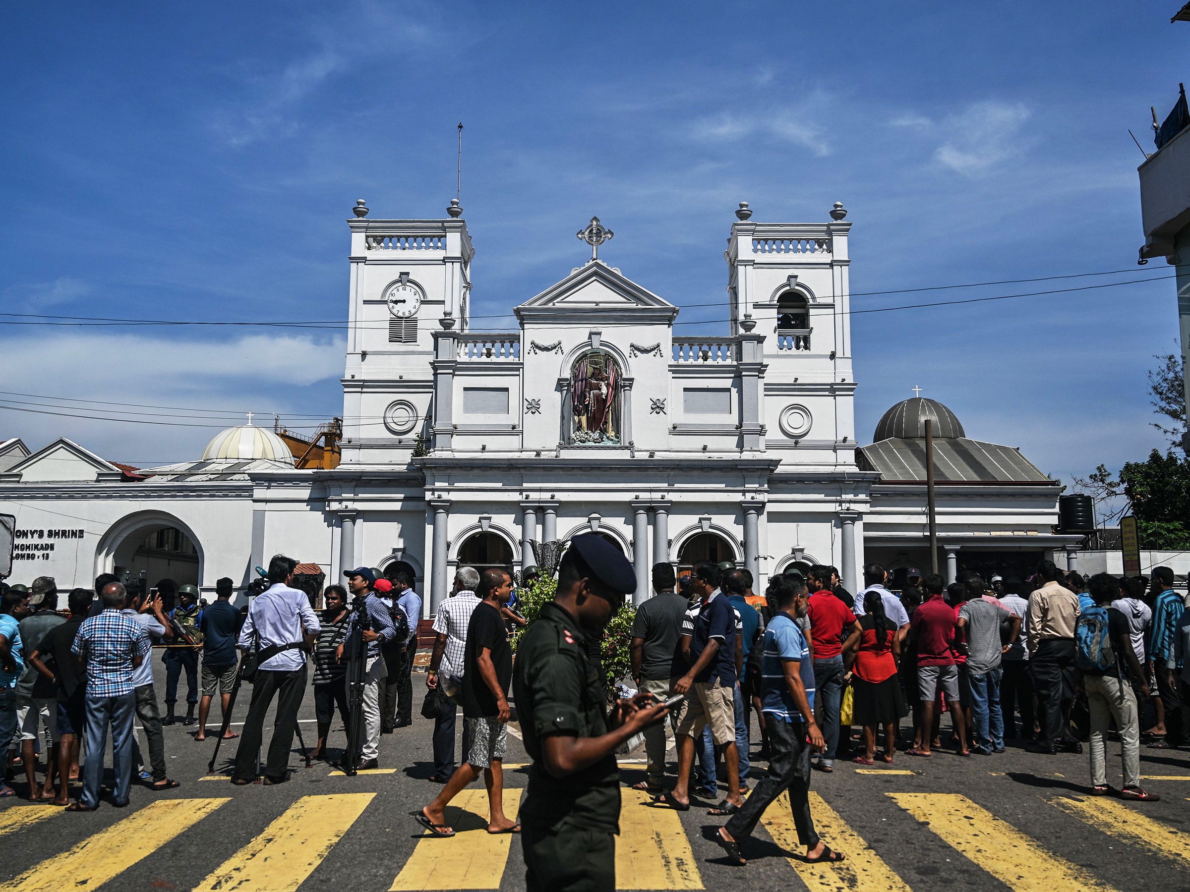 Local residents gather outside the St. Anthony's Shrine in Colombo Sri Lanka.