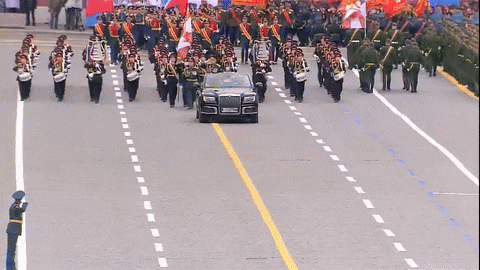 a large group of soldiers are lined up in a row with one holding a flag that says russia on it