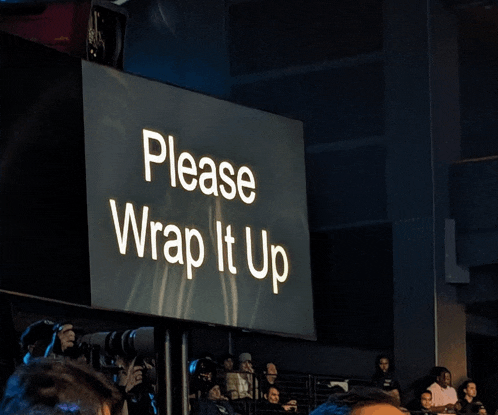 a large screen says please wrap it up