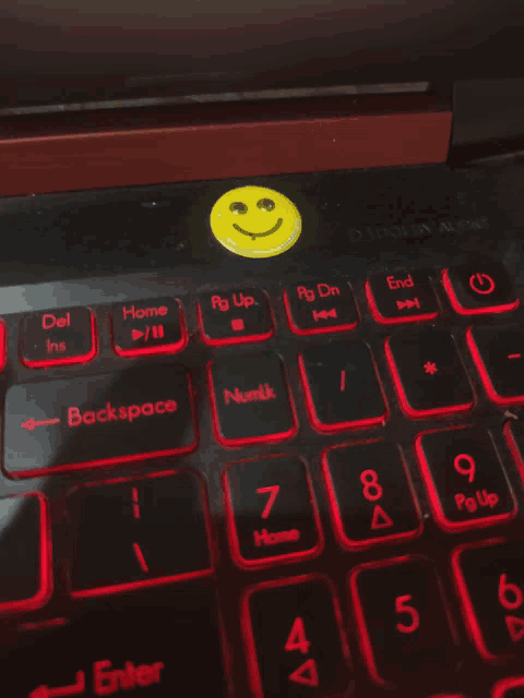 a laptop with a smiley face on the bottom of the keyboard