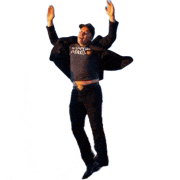 a man is jumping in the air with his arms in the air while wearing a shirt that says the north face