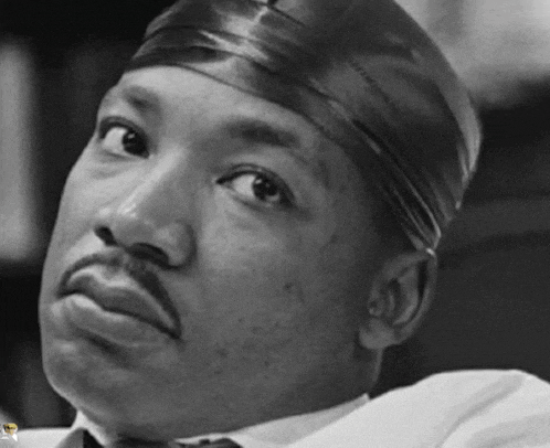 a black and white photo of a man wearing a satin headband