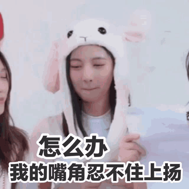 a girl wearing a white bunny hat with chinese writing