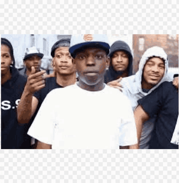 a group of young men standing next to each other wearing hats .