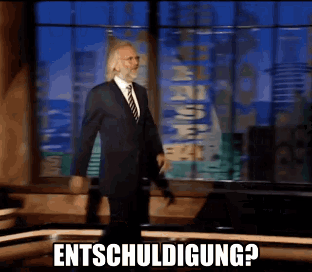 a man in a suit and tie stands in front of a window with the words entschuldigung on the bottom