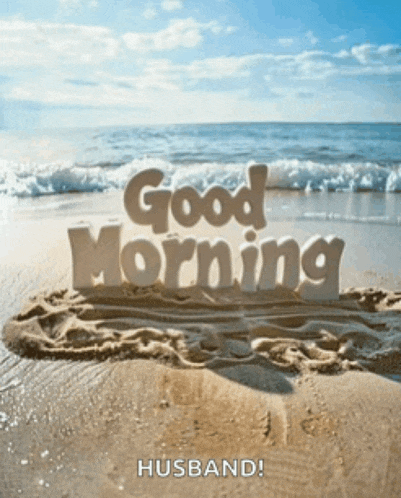 a sand sculpture of the words good morning husband on a beach