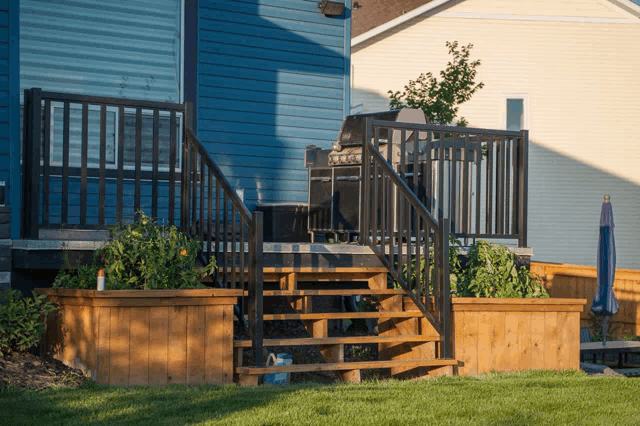 a deck with stairs leading up to it and a grill on it