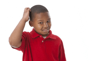 a young boy wearing a red shirt is scratching his head