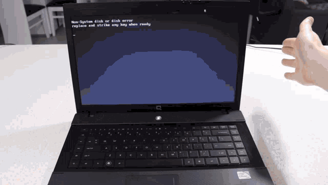 a laptop with a blue screen that says non-system disk or disk error replace and strike any key when ready