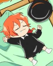 a little girl with orange hair is laying on a bed with a hat on top of her head .