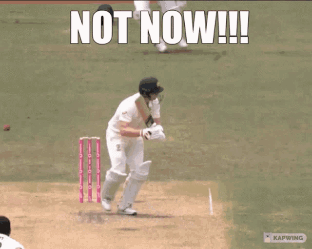 a cricket player is swinging at a ball with the caption not now