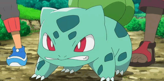 a green pokemon with red eyes is standing on a dirt path