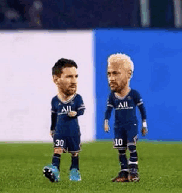 two soccer players with their faces on them are standing on a field .