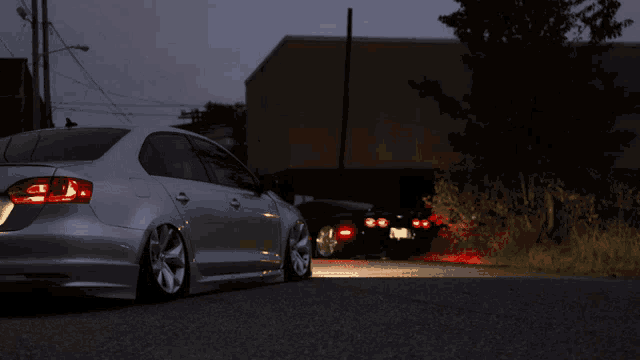 a silver car is parked on the side of a road