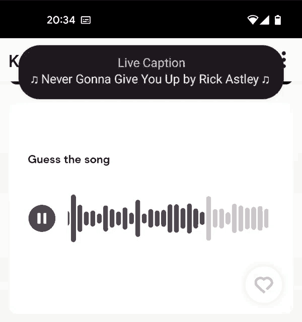 a phone screen shows a live caption of a song called never gonna give you up by rick astley