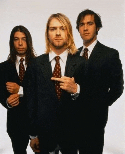 three men in suits and ties are posing for a photo