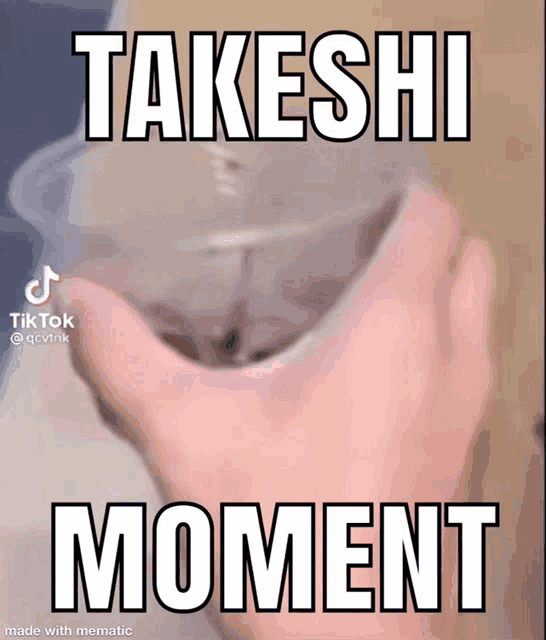 a person holding a cup with the words takeshi moment on it