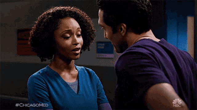 a man in a purple shirt is hugging a woman in a blue jacket with the hashtag #chicagomed