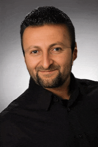 a man with a beard wears a black shirt