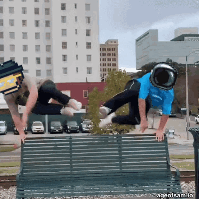 two men are jumping over a park bench with ageofsam.io written on the bottom right