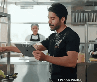 a man in a black shirt is looking at a tablet in a kitchen with the words 1 pepper pizette on the bottom