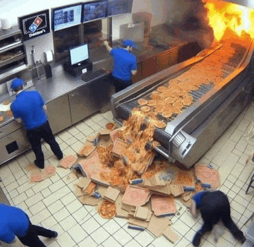 domino 's pizza is on fire in a kitchen