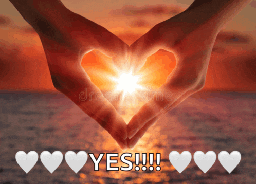 a person making a heart shape with their hands with the word yes below