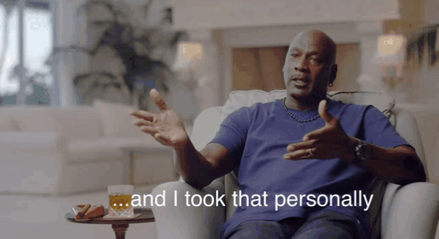 a man sitting in a chair with the words " and i took that personally " behind him