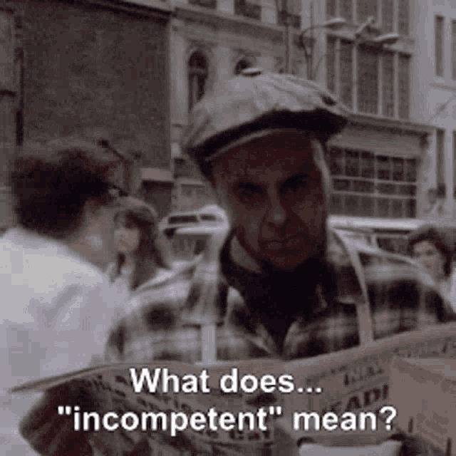 a man in a hat is reading a newspaper and says what does incompetent mean .