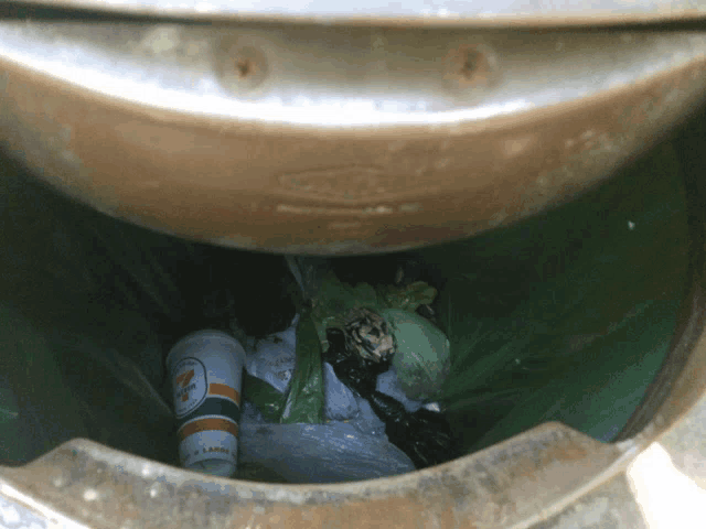 the inside of a trash can with a 7 eleven cup in it