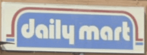 a daily mart sign that is on a brick wall