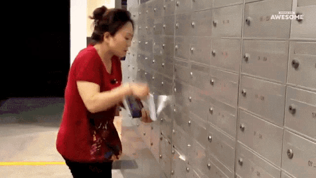 a woman in a red shirt is putting a piece of paper in a mailbox with the words awesome on the bottom