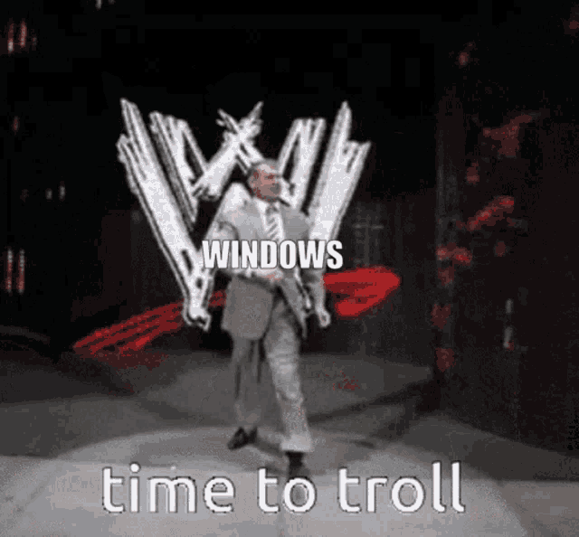 a man in a suit and tie is walking on a stage in front of a w logo and says windows time to troll