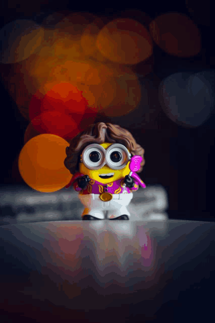 a toy minion with a purple shirt and a comb