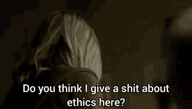 a woman is talking about ethics in a dark room .