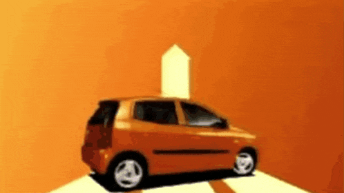 an orange car is parked in front of an orange wall with an arrow pointing up .