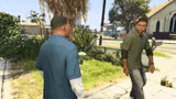 two men are standing on a sidewalk in a video game talking to each other .