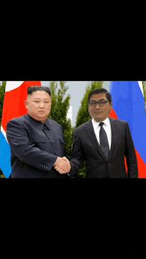 a man in a suit shakes hands with another man in front of flags